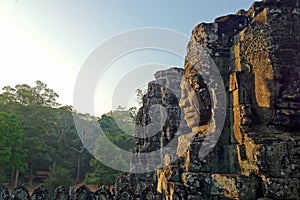 Side view of a sculpted face of a deity on one of the towers of Bayon temple in Angkor historical complex at Siem Reap, Cambodia