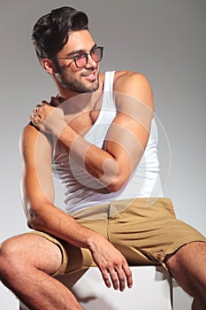 Side view of a seated man with hand on shoulder