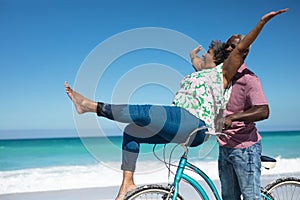 Old couple with bikes at the beach