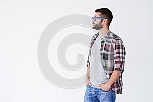 Side view of serious bearded man looking sideward at copy space