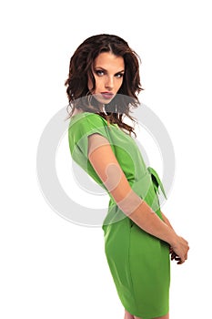 Side view of a woman in green dress standing