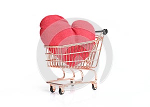 Side view of shopping cart with big red heart isolated on white background