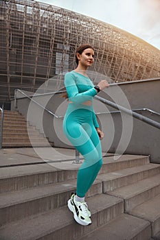 Side view shot of fitness woman running  on steps. Female runner athlete going down stairs