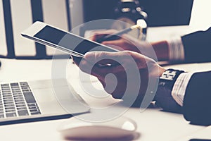 Side view shot of a man's hands using smart phone in interior, r