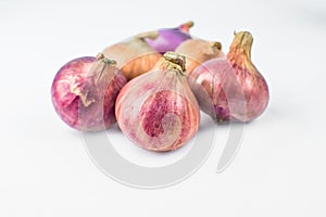 Side view of six medium size fresh and ripe red onion isolated on a white background