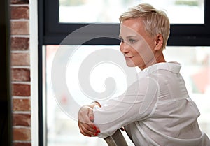 Side view on smiling business woman