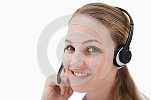 Side view of smiling call center agent with headset