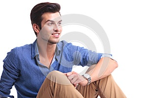 Side view of a smiling casual man looking away