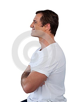 Side view of smiling mature man with arms crossed