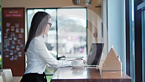 Side view smiling pretty businesswoman in glasses enjoying having break drinking coffee