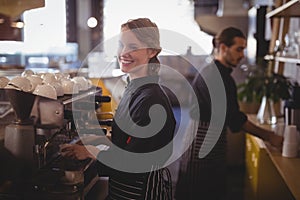 Side view of smiling young baristas