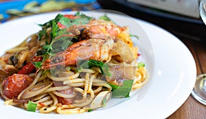 side view spicy spaghetti stirfried seafood thai food, tum yum talay