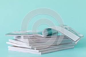 Side view of a stack of magazines with glossy paper