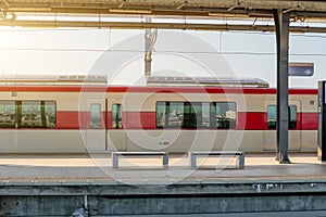 Side view of the station platform and commuter train in the parking lot.