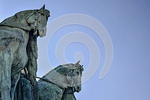 Side view on statue horses of  the chieftains of the Magyars against a blue sky. Fragment of the Millennium Monument on the Heroes