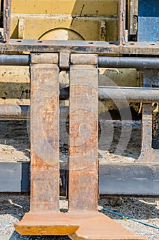 Side view of steel forks of industrial forklift