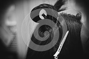 Side View of a Strand of Female Hair with a Clip. Close-up. Black and White image. Hair Styling Process