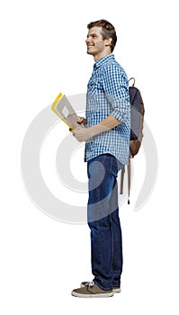 Side view of a student . The guy with the backpack and textbooks