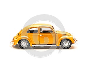 Side view studio shot small orange toy car isolated on white