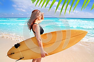 Side view surfer woman tropical sea looking waves