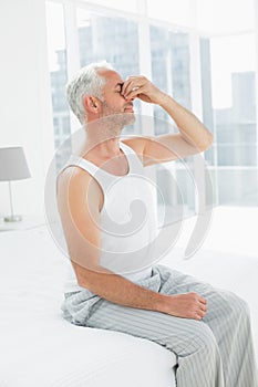 Side view of a thoughtful mature man in bed