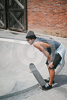 side view of tired handsome skater resting