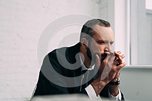 side view of tired and pensive businessman