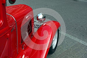 Side view to fragment of retro hot rod car color red closeup
