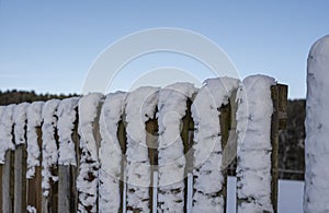 Side view to wooden fence in winter