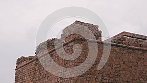 Side view of top of fortress. Side view of towers of fortress. Ruined towers of castle. Close up view of castle`s towers. Signific