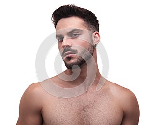 Side view of a topless unshaved man looking confident
