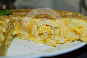 Side view of a tortilla de patatas sliced, you can see the interior of it photo