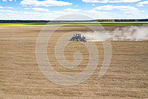 Side view of tractor planting corn seed in field, high angle view drone photography