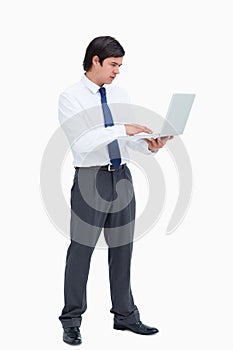 Side view of tradesman working on his laptop