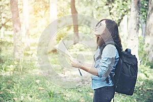 Side view of traveler woman searching right direction on map