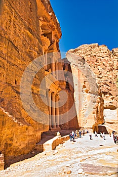 Side view of the treasury in Petra, Wadi Musa in Jordan, with tourists in front of the majestic architecture