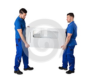 Side View Of Two Movers Holding Furniture