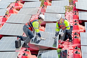 Side view of two professional technician workers hold solar cell panels with touch to check problem during installation or set up