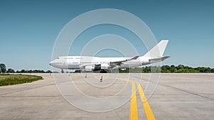 Side view of two-storey jumbo jet on a ground on a sunny day