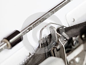 Side view of typebar hits ink ribbon in typewriter