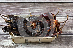 Side view of various dried Pasilla, Cascabel, Guajillo hot chili peppers photo