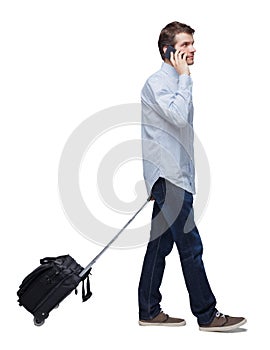 Side view of walking business man with suitcase talking on the phone