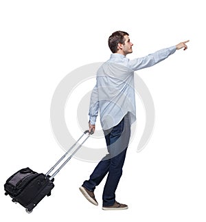 Side view of walking pointing business man with suitcase