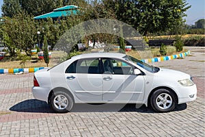 Side view of a white corolla car: Swat, Pakistan - 10 October 2023