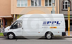 Side view of white delivery Ford Transit van of PPL company, partner of global DHL postal service, parked when delivering parcels