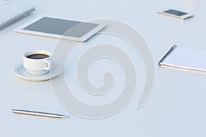 Side View of White Table with Electronics and Stationary
