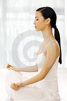 Side view of woman practicing yoga