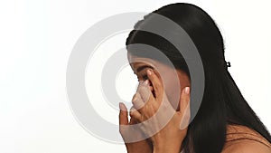Side view of woman putting in contact lens.