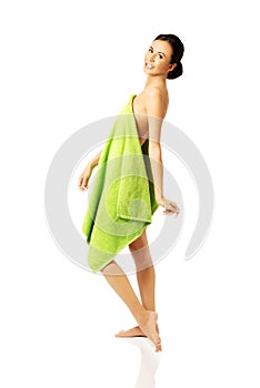 Side view woman standing wrapped in towel