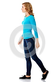 Side view of a woman walking slowly